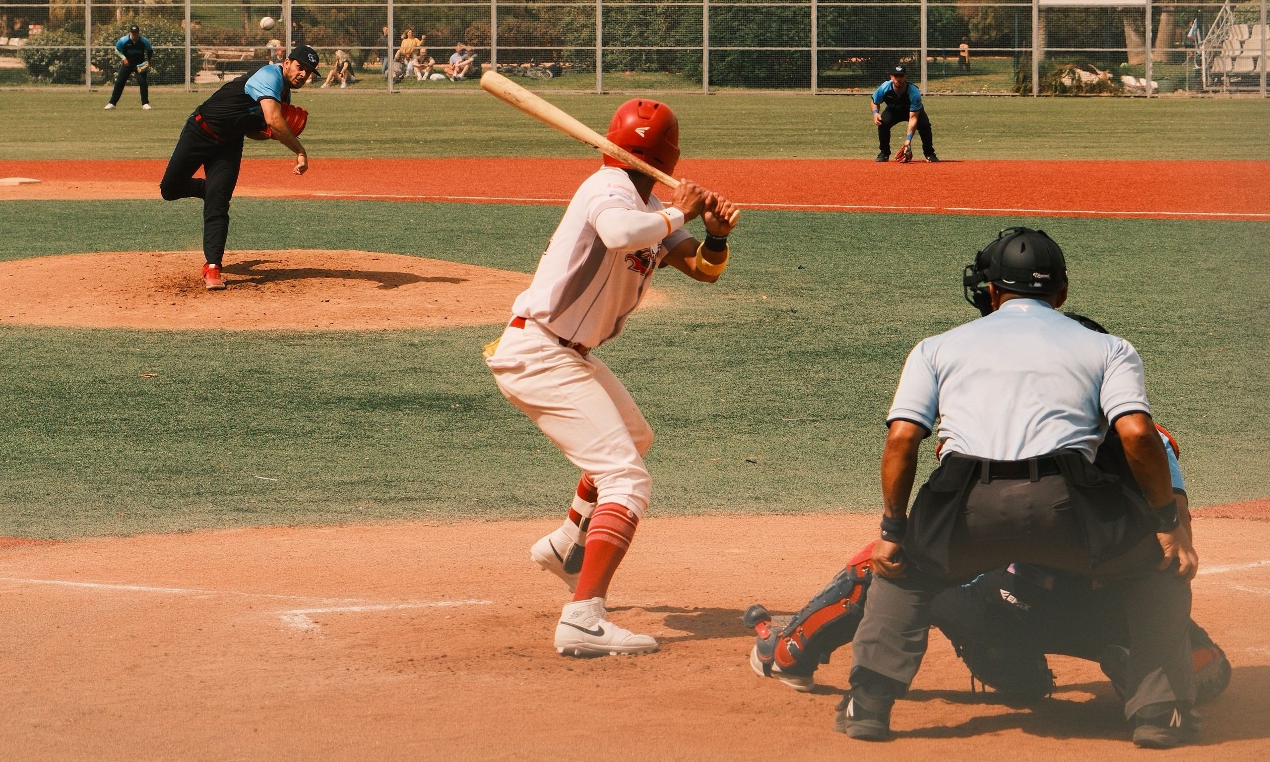 Baseball game viewed from behind the batter, with the pitcher preparing to throw the ball and the catcher positioned behind home plate.Baseball game viewed from behind the batter, with the pitcher preparing to throw the ball and the catcher positioned behind home plate.