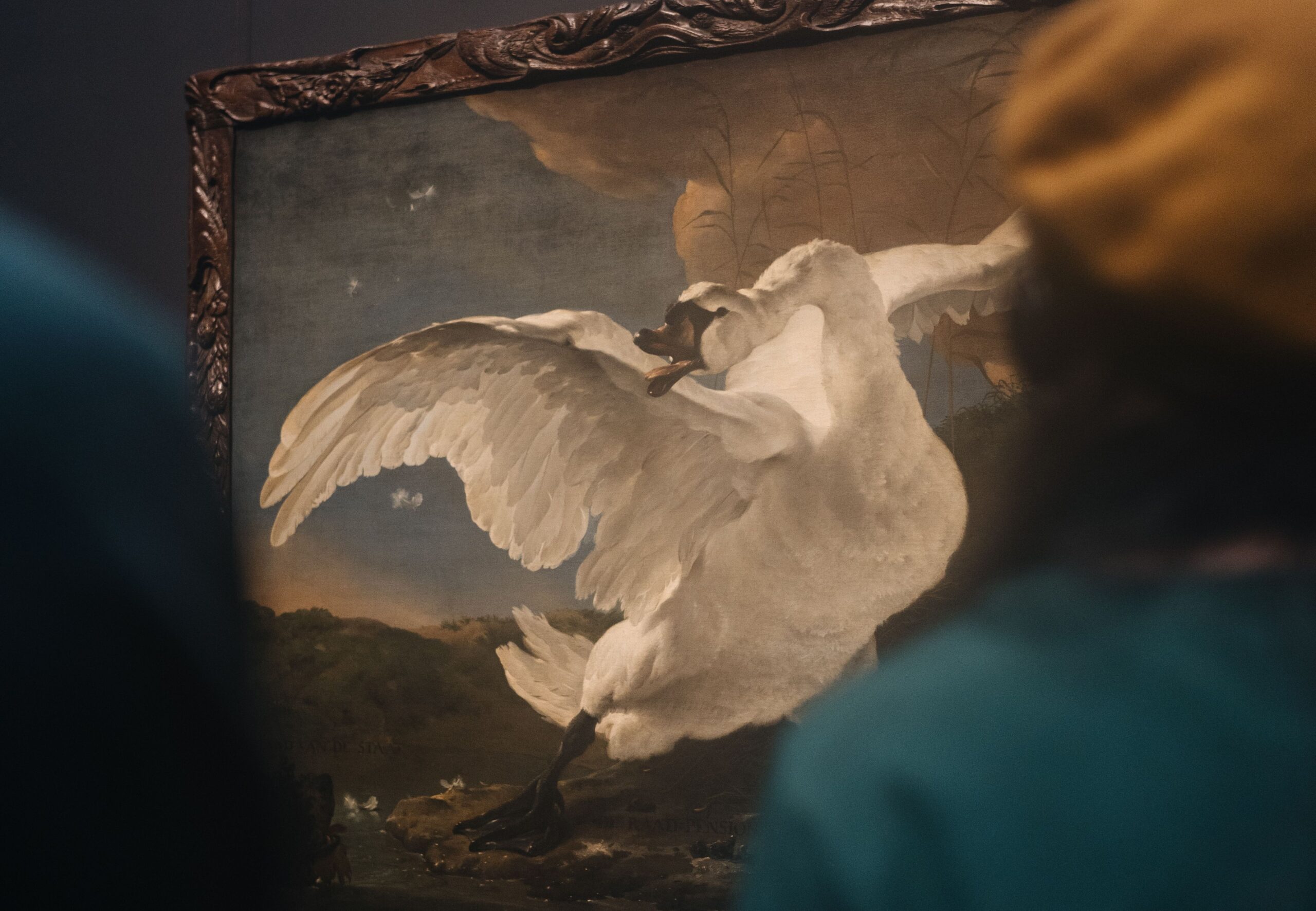 Blurred person viewing a painting of a goose in an aggressive stance.